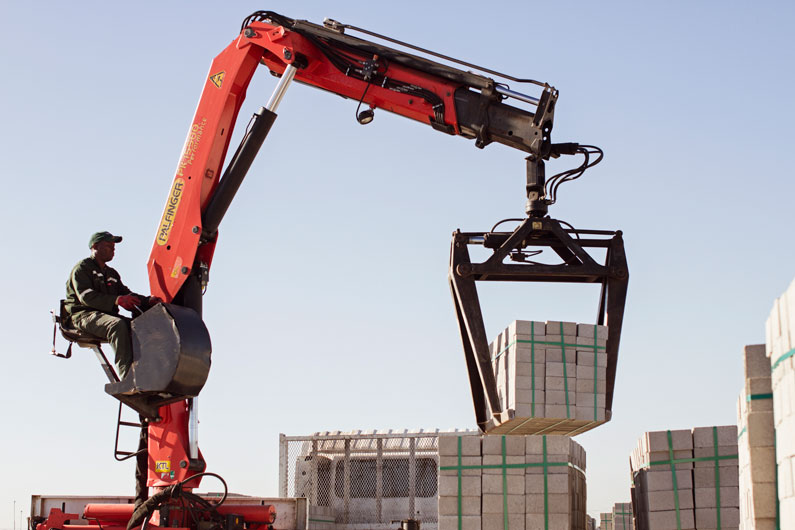 Mini Build worker on a crane loading building bricks