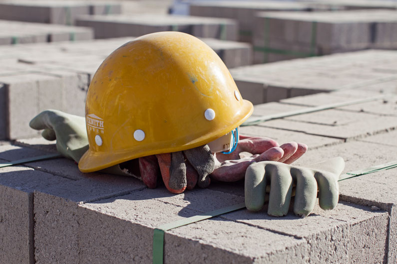 Hard hat & gloves ontop of building bricks