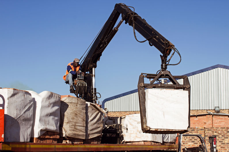 Mini Build worker on a crane loading building material